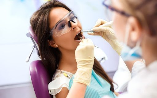 A woman receives a dental exam.